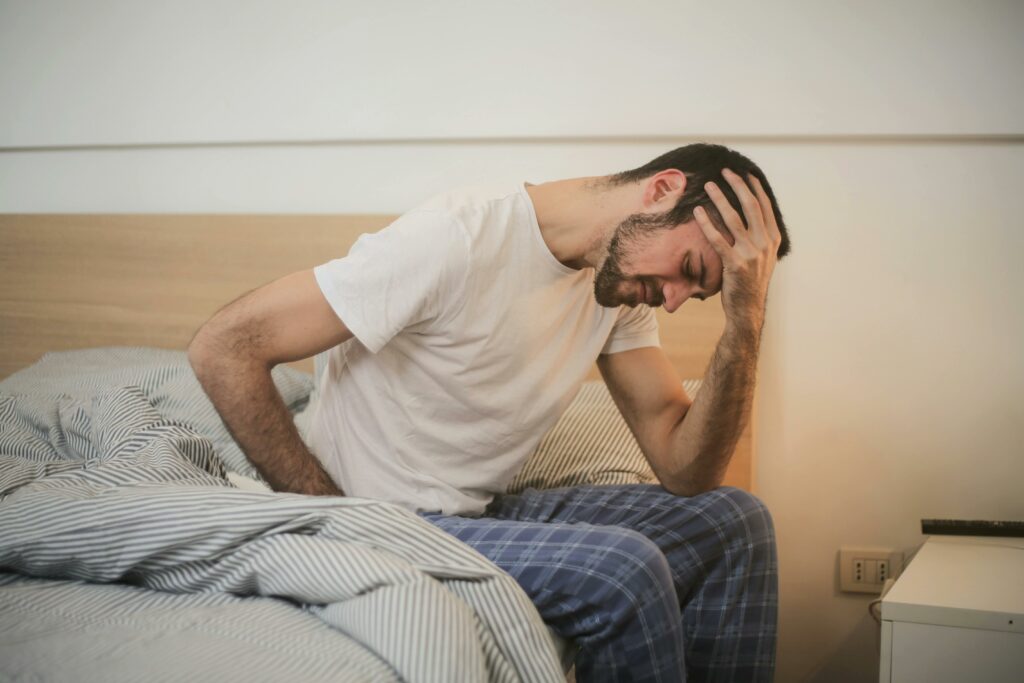 man with head in hands representing steroid withdrawal
